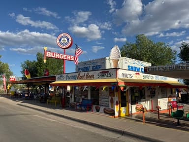 Un restaurant coloré avec des panneaux et des sièges en plein air.