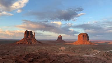 Three iconic rock formations under a cloudy sky in Arizona.