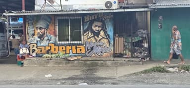 Un mur coloré avec des portraits et des légumes sur le sol.
