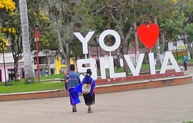 Deux personnes marchent près d'un grand panneau 'YO ♥ SILVIA'.