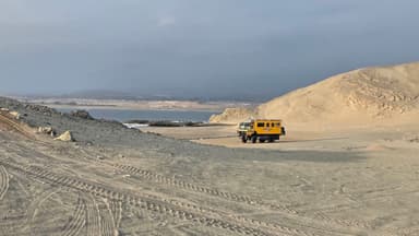 Un véhicule jaune sur une plage désertique à Huacho, au Pérou.