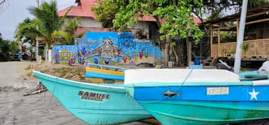 Deux bateaux de pêche colorés près d'un mur peint à Ecuador.